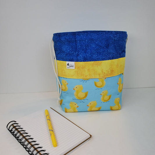 This rubber ducky inspired bag is blues and yellows with drawstring closure